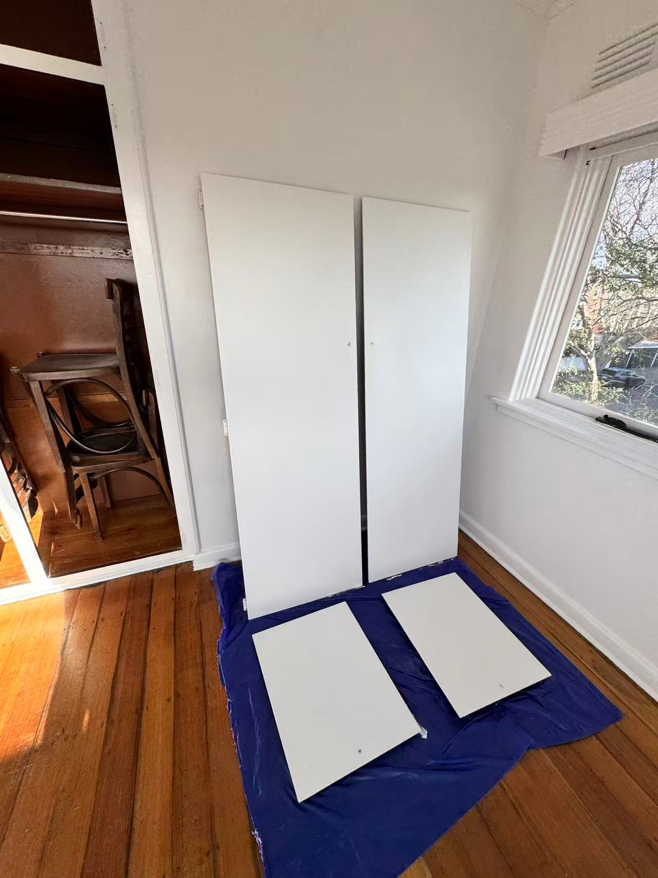 White detached panels beside an interior opening
